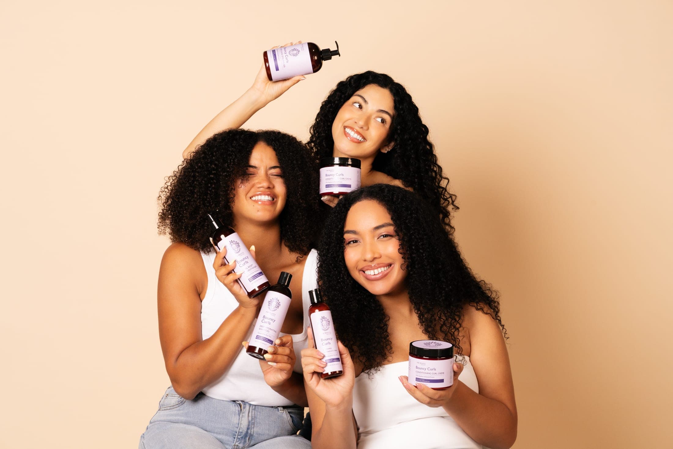 The Roots Naturelle — natural hair and body care, held by three women