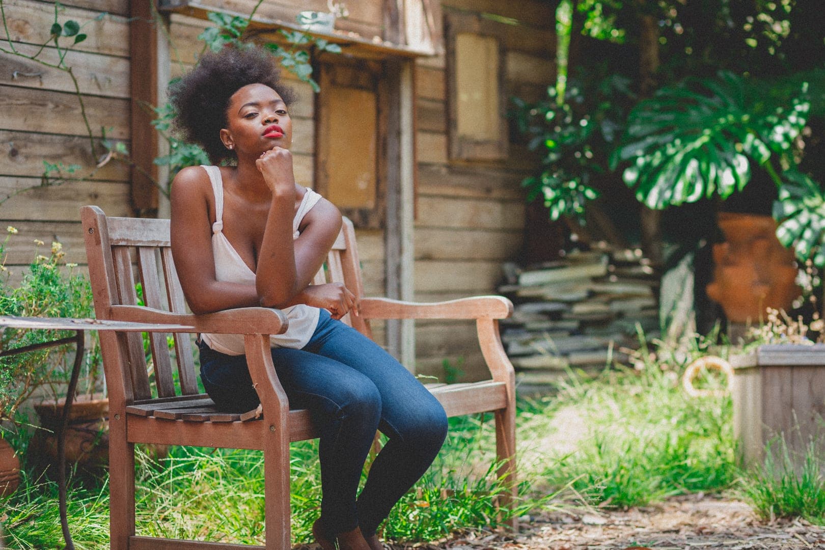 Natural botanicals — a model surrounded by lush greenery